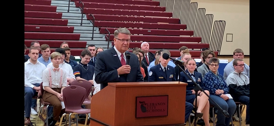 man speaking at a podium